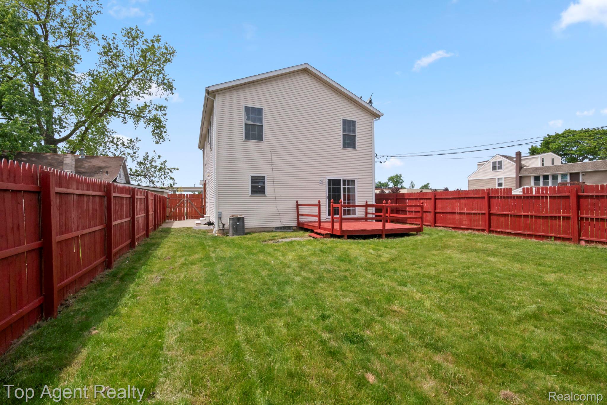 2018 John R Road Troy, MI 48083 - Photo 25 of 30 Rear view of house with a wooden deck and a fenced backyard