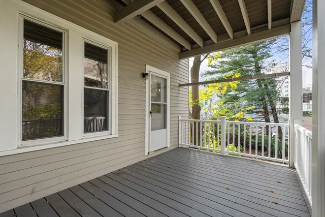 a view of a balcony with wooden floor