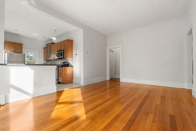 a view of kitchen with wooden floor and electronic appliances