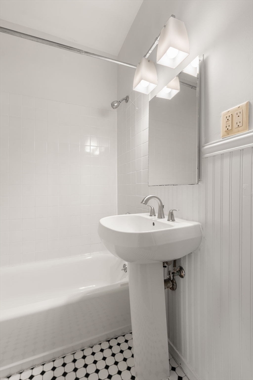 15 Trowbridge Street, Unit 8 Cambridge, MA 02138 - Photo 14 of 17 a bathroom with a sink a mirror a bathtub and a shower