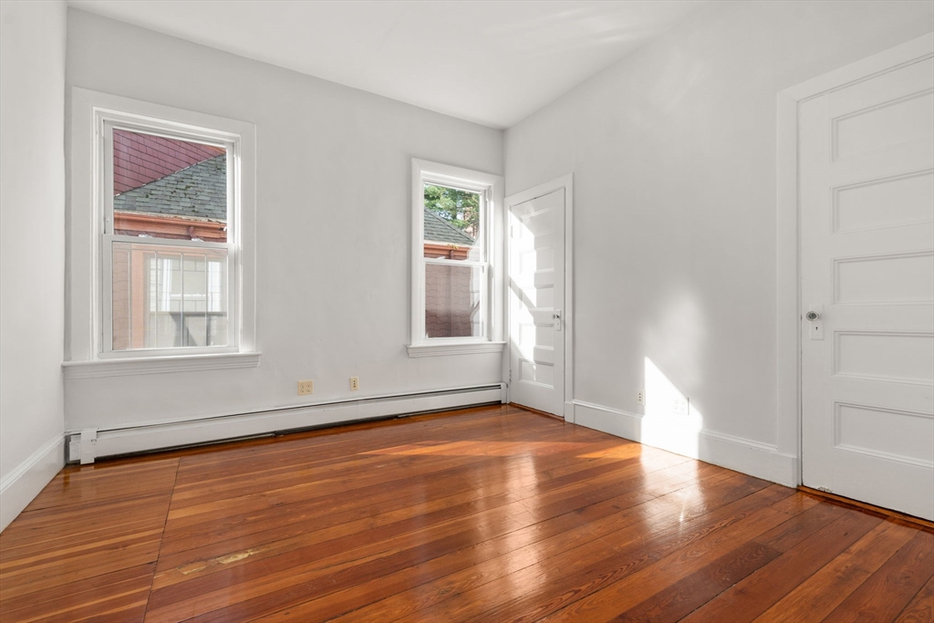 15 Trowbridge Street, Unit 8 Cambridge, MA 02138 - Photo 17 of 17 a view of an empty room with wooden floor and a window