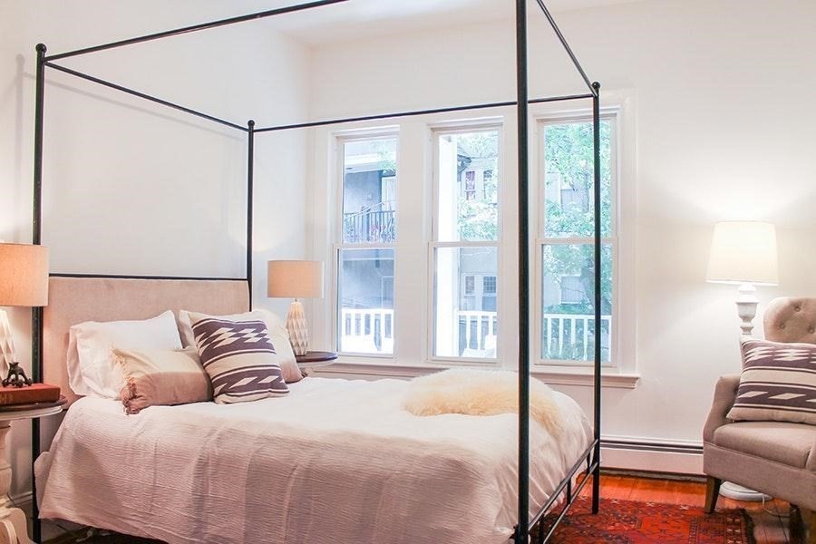 15 Trowbridge Street, Unit 8 Cambridge, MA 02138 - Photo 3 of 17 a bedroom with a bed and a chandelier