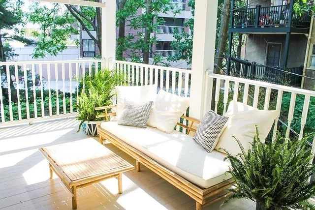 a view of a chairs and table in the balcony