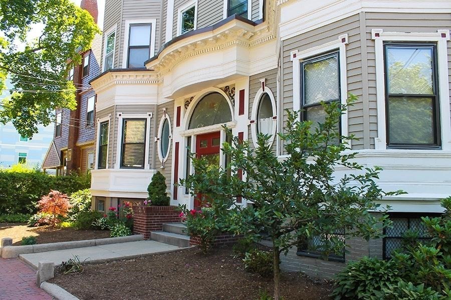 15 Trowbridge Street, Unit 8 Cambridge, MA 02138 - Photo 7 of 17 a view of a white house with a fountain and potted plants