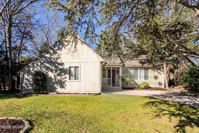 a house view with swimming pool in front of it