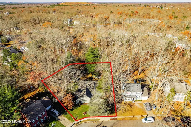 a front view of a house with a yard and potted plants