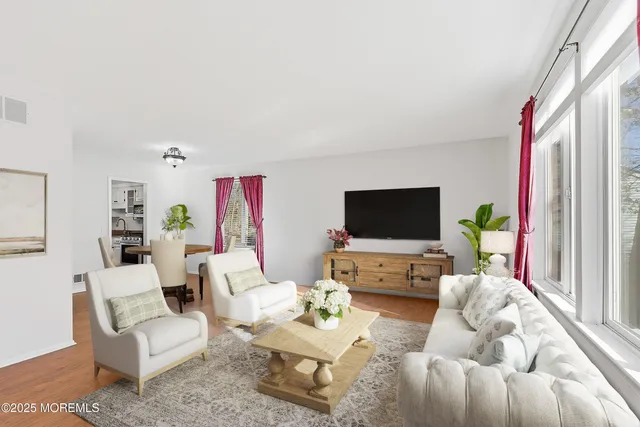 a living room with a fireplace with wooden floor