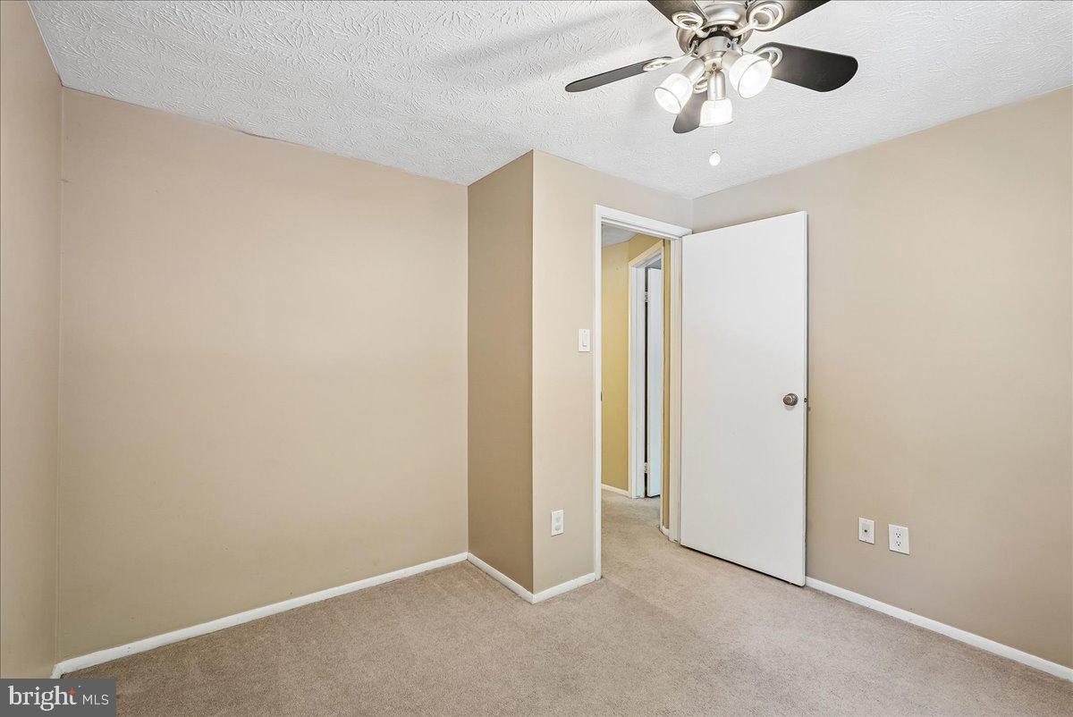 2331 Middle Creek Lane Reston, VA 20191 - Photo 34 of 78 an empty room with a chandelier fan and a chandelier fan