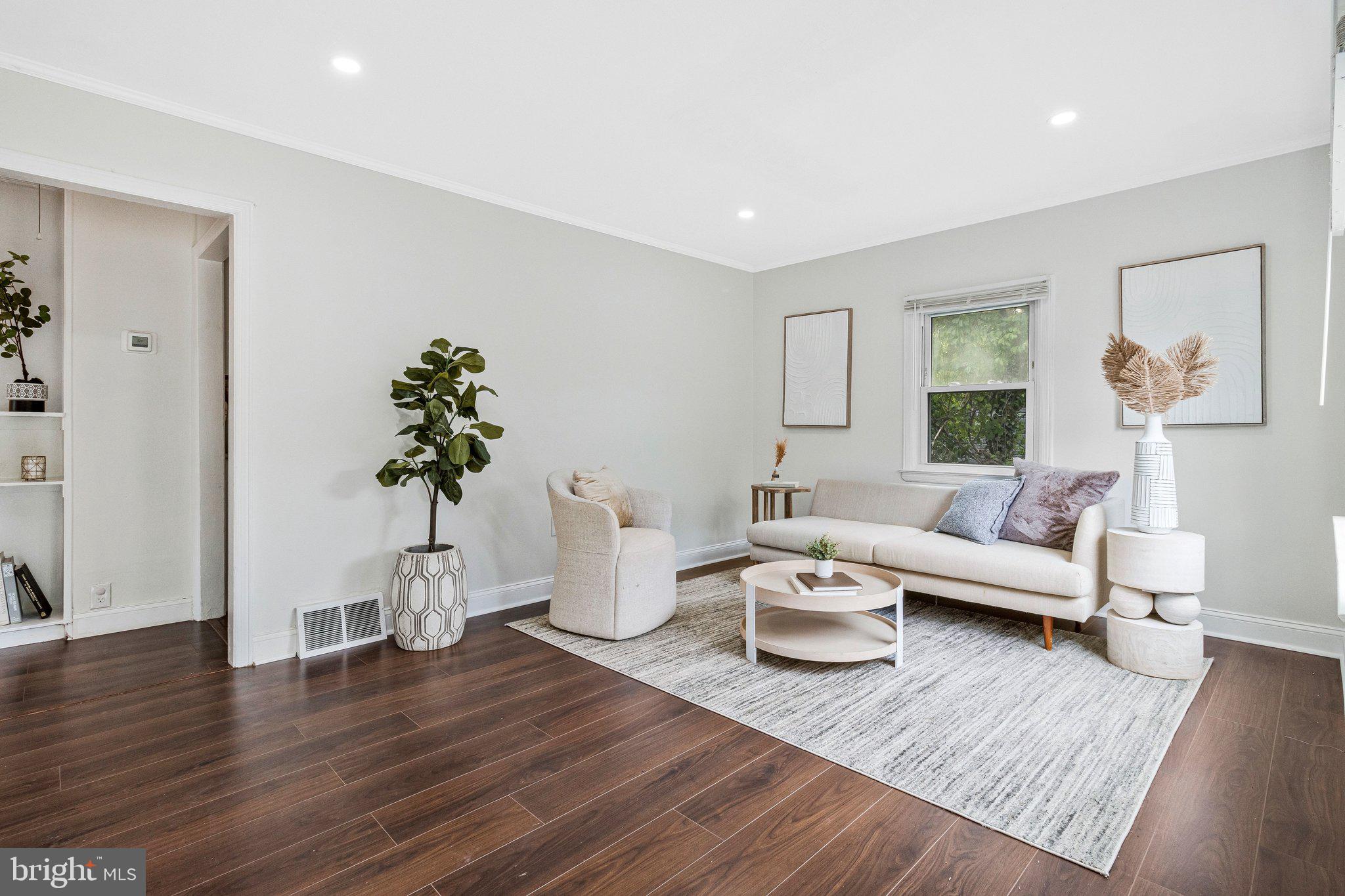 11515 Goodloe Road Silver Spring, MD 20906 - Photo 3 of 33 a living room with furniture potted plant and wooden floor