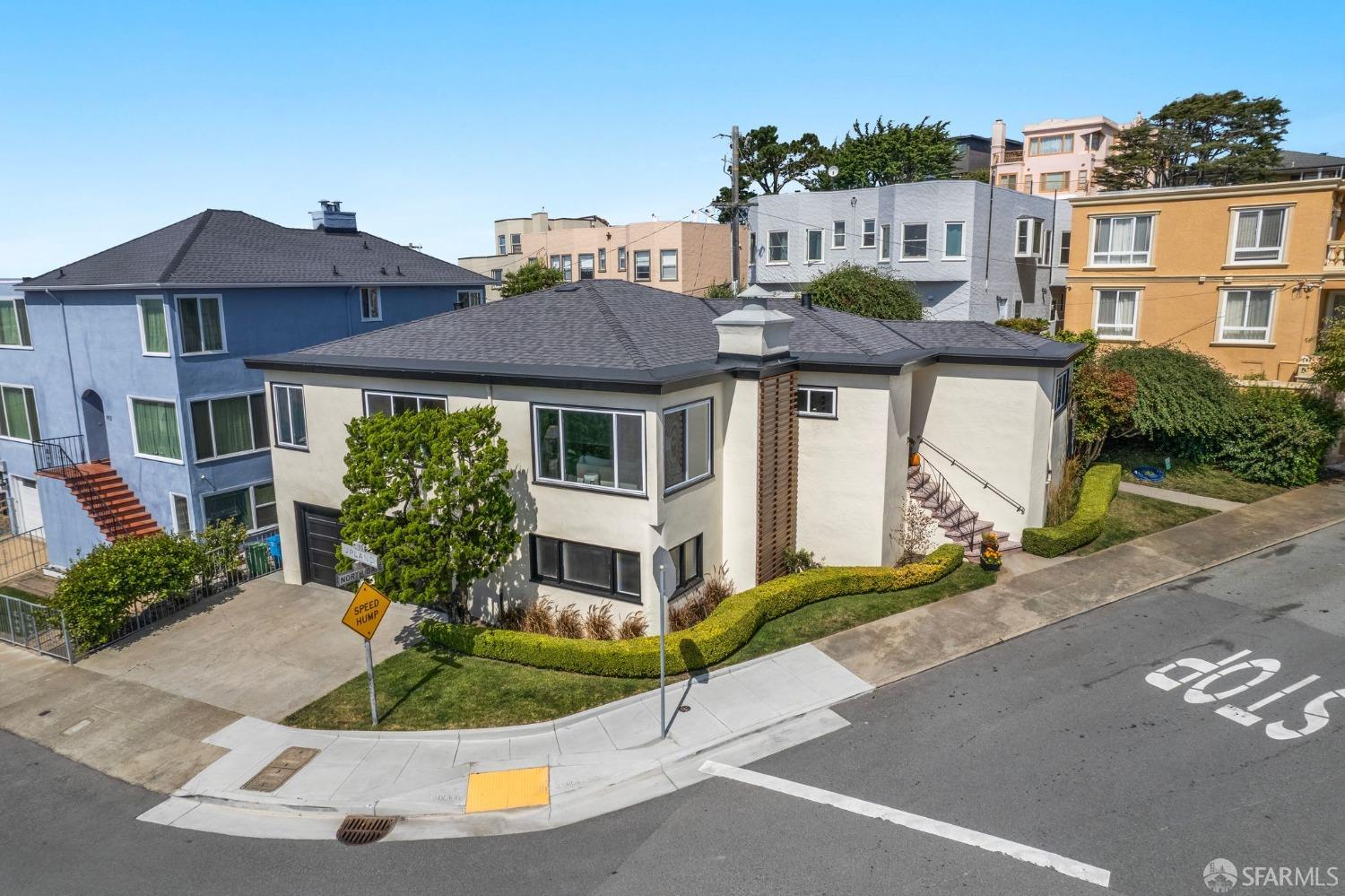 a front view of a house with a garden