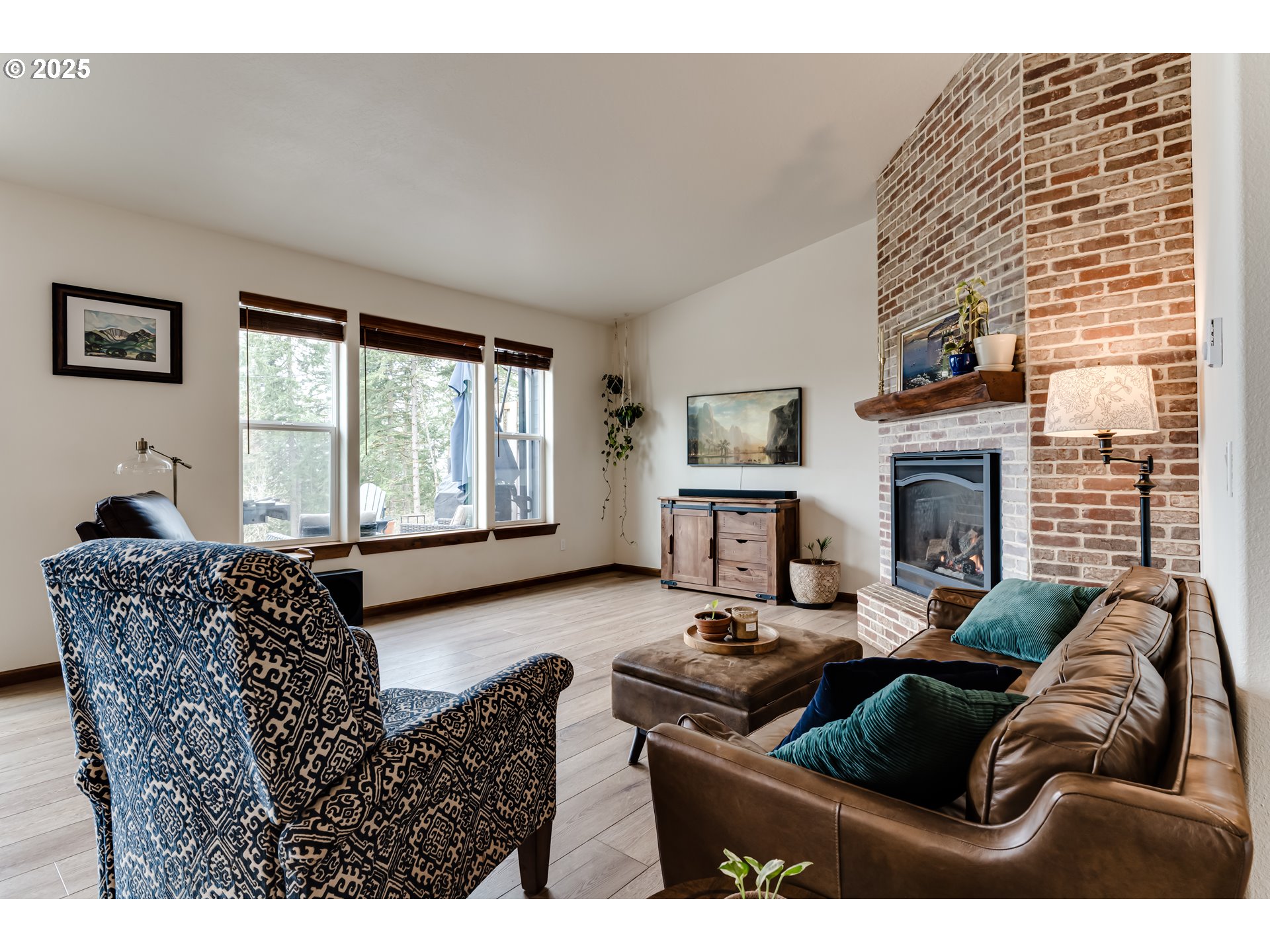 31490 Fox Hollow Road Eugene, OR 97405 - Photo 18 of 40 a living room with furniture a fireplace and a large window