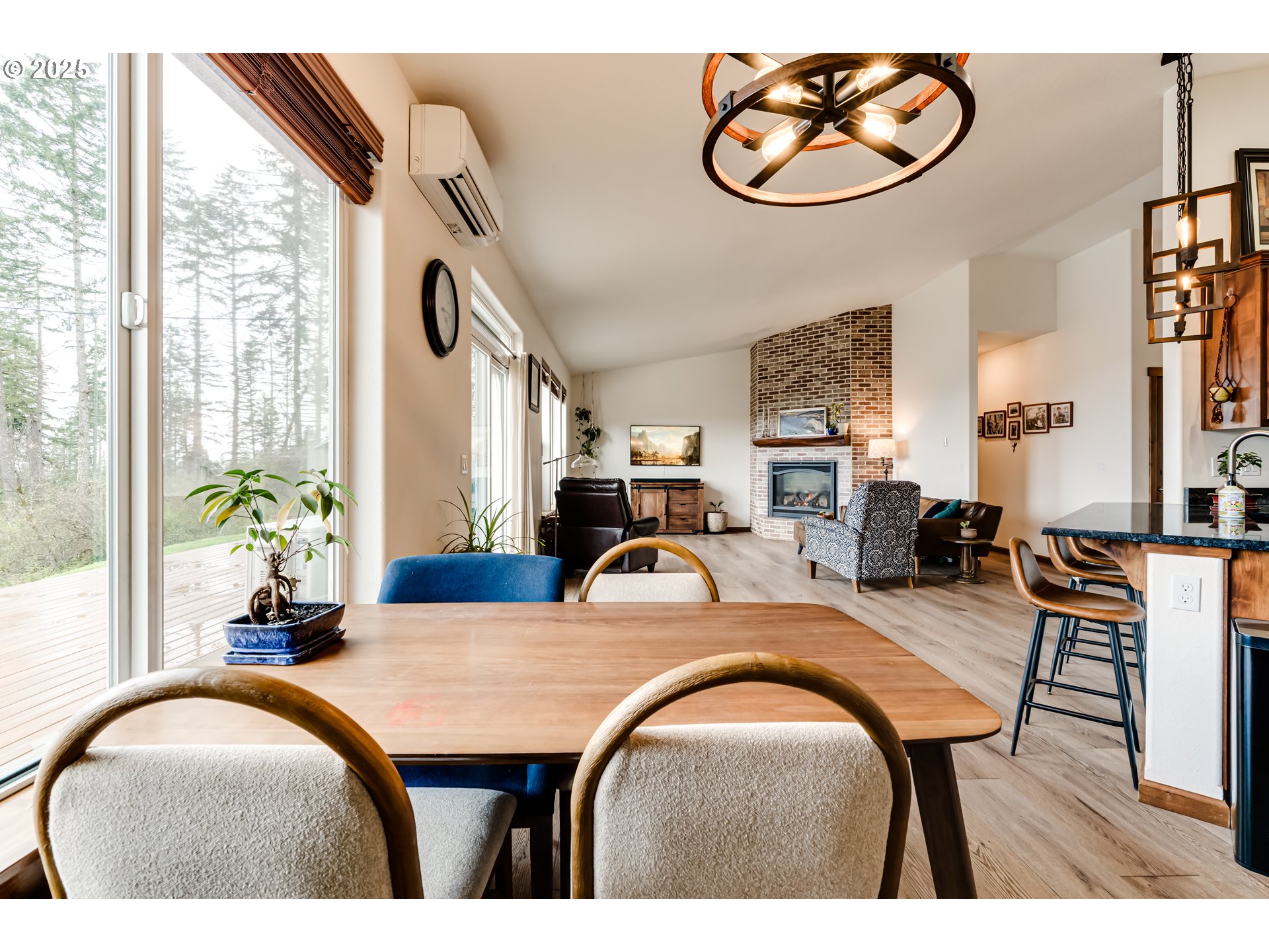 31490 Fox Hollow Road Eugene, OR 97405 - Photo 22 of 40 a dining room with furniture potted plants and wooden floor
