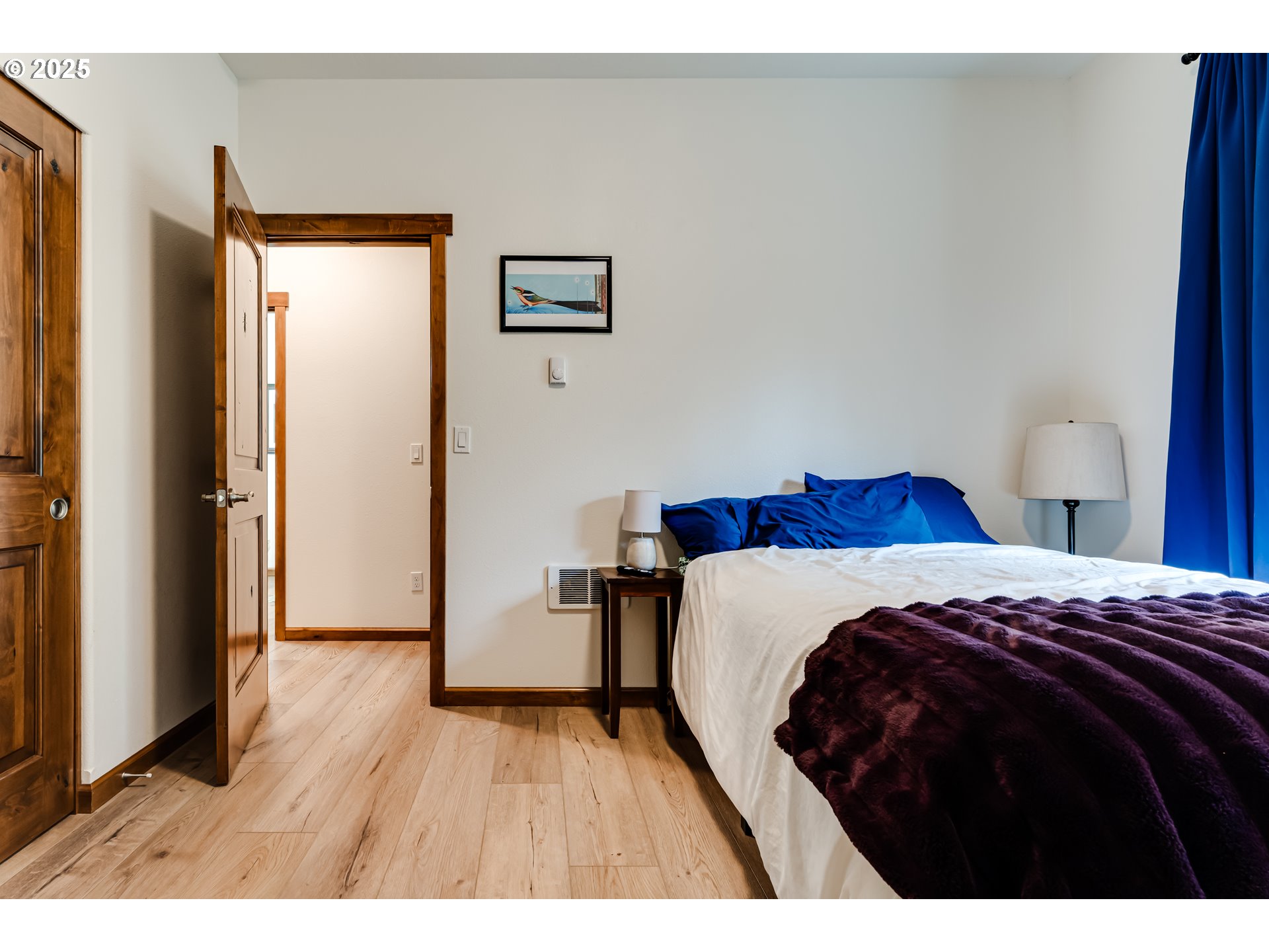 31490 Fox Hollow Road Eugene, OR 97405 - Photo 33 of 40 a bedroom with a bed and a wooden floor