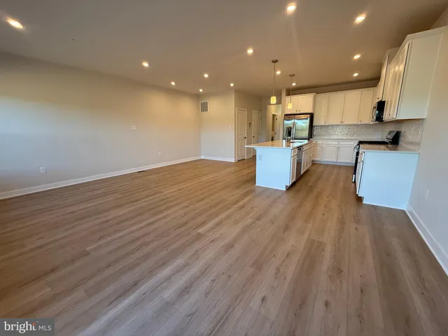 a living room with kitchen island furniture and a wooden floor