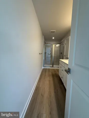 a view of hallway with wooden floor