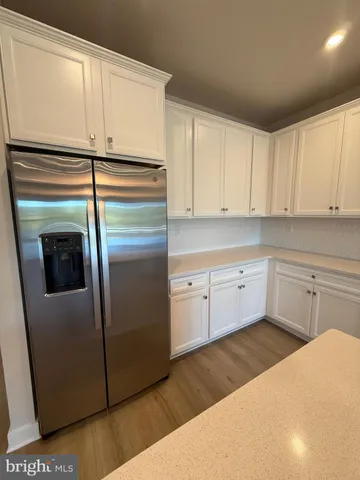 a kitchen with cabinets and stainless steel appliances