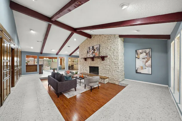 a living room with fireplace furniture and a large window