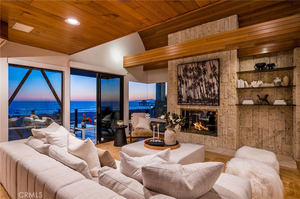 708 The Strand Manhattan Beach, CA 90266 - Photo 1 of 27 a living room with furniture a fireplace and table
