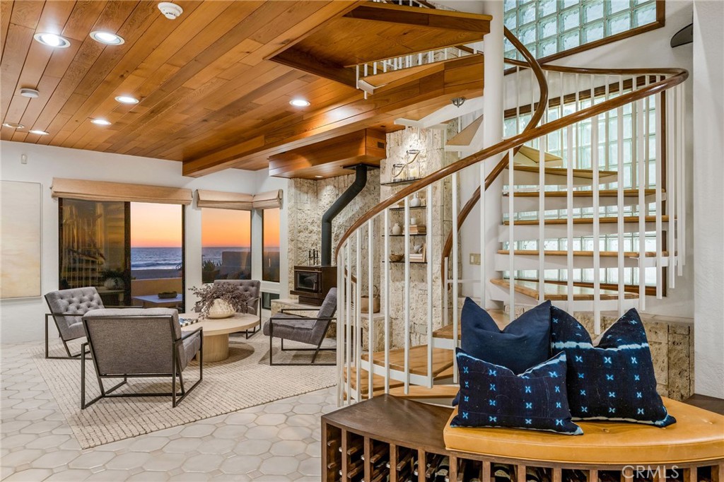 708 The Strand Manhattan Beach, CA 90266 - Photo 21 of 27 a living room with couches a dining table and chairs with wooden floor
