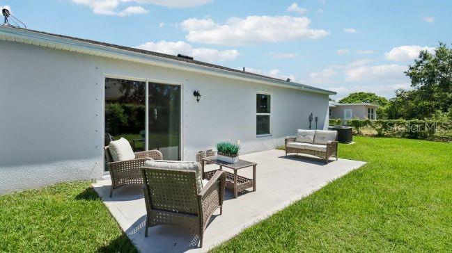 16290 Kakawi Road Weeki Wachee, FL 34614 - Photo 18 of 22 a view of a house with backyard sitting area and garden