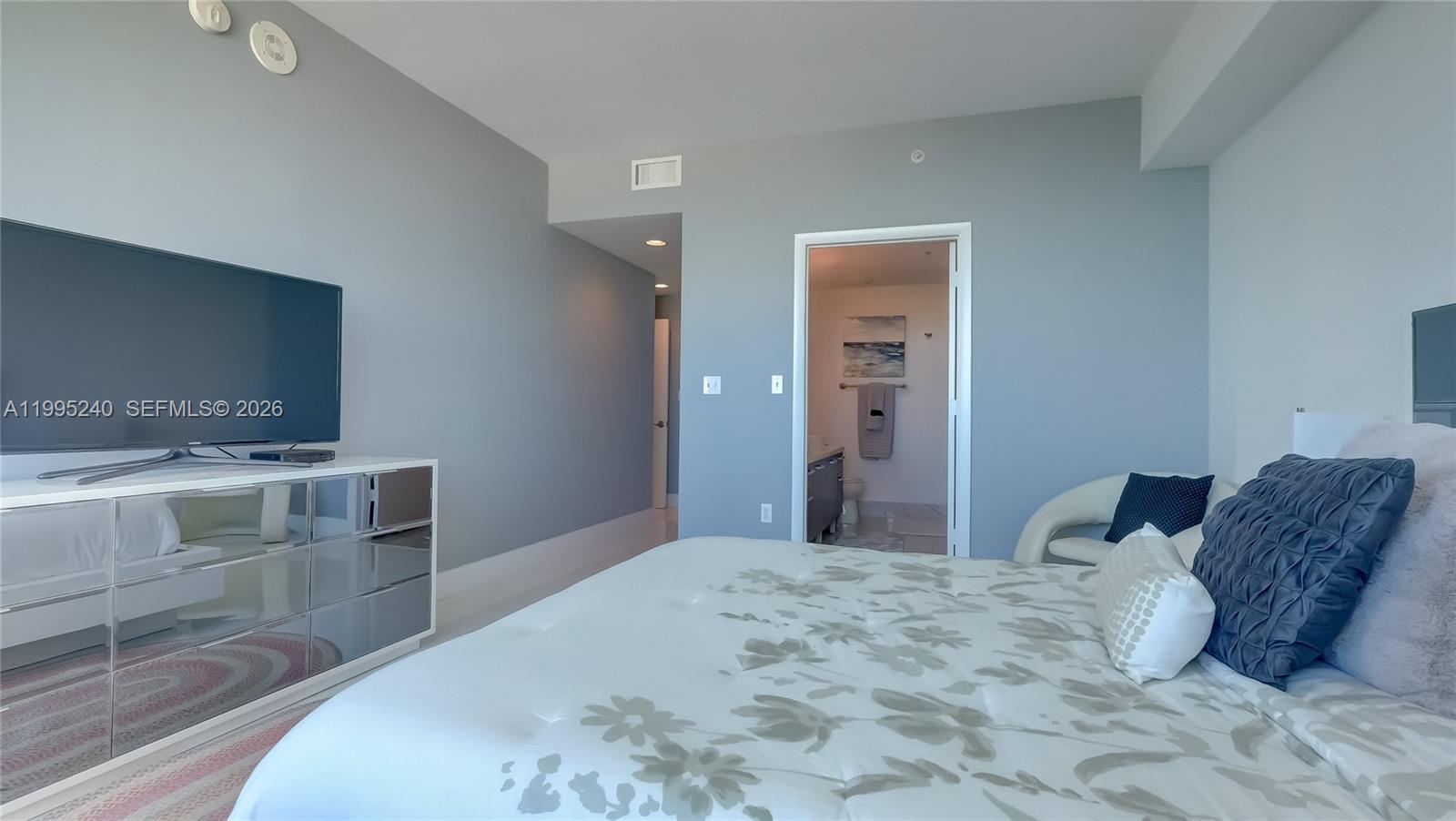 253 Northeast 2nd Street, Unit 3509 Miami, FL 33132 - Photo 30 of 49 a bedroom with a bed and a dresser