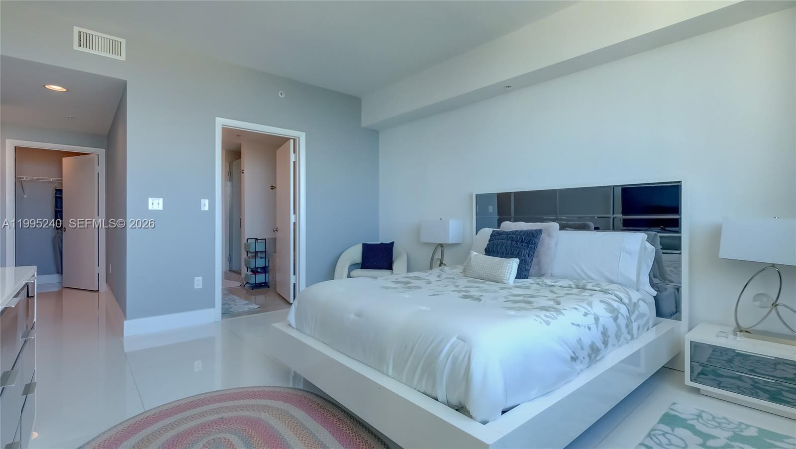 253 Northeast 2nd Street, Unit 3509 Miami, FL 33132 - Photo 31 of 49 a bedroom with a large bed and a view of bathroom
