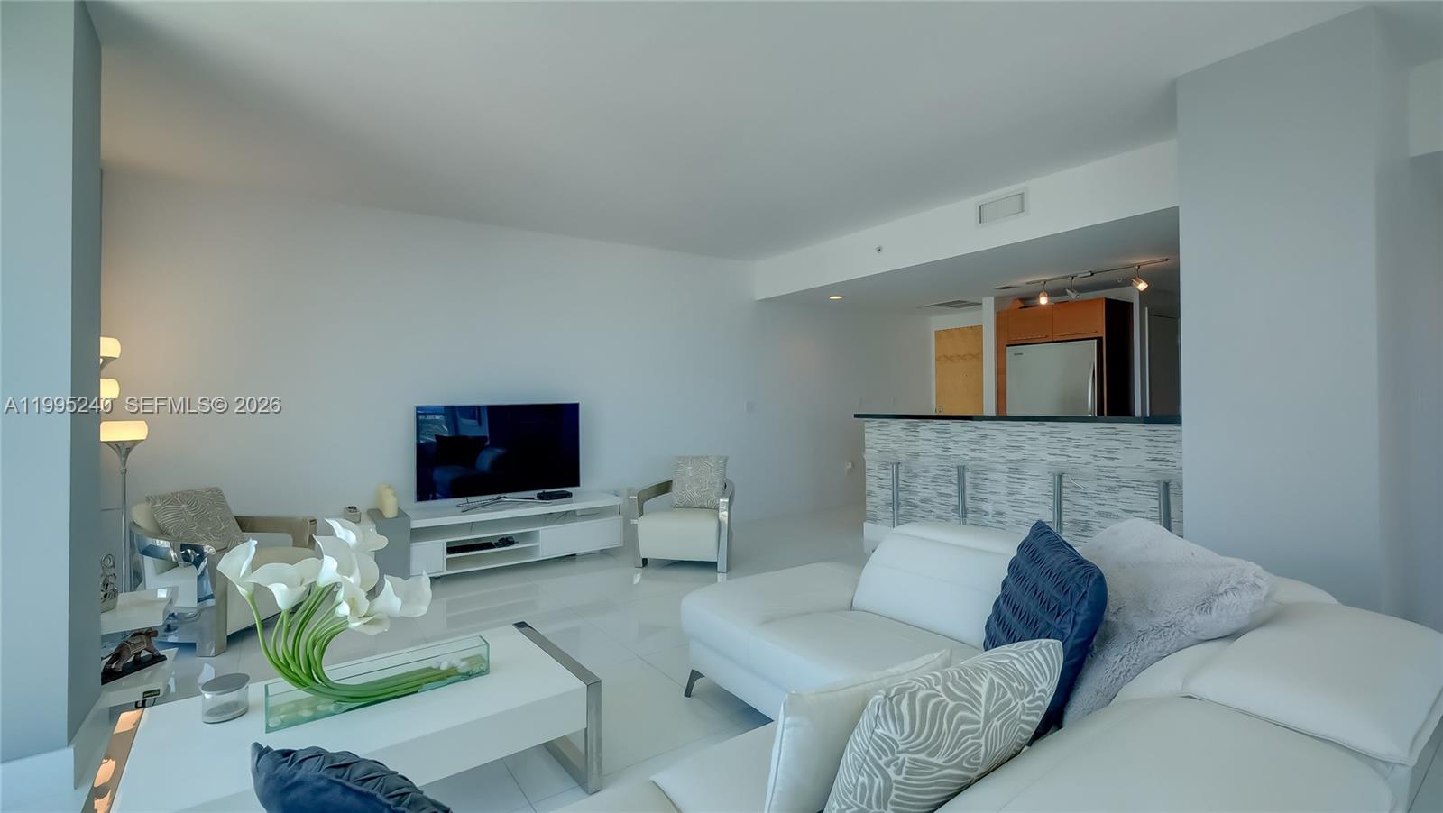 253 Northeast 2nd Street, Unit 3509 Miami, FL 33132 - Photo 42 of 49 a living room with furniture and a flat screen tv