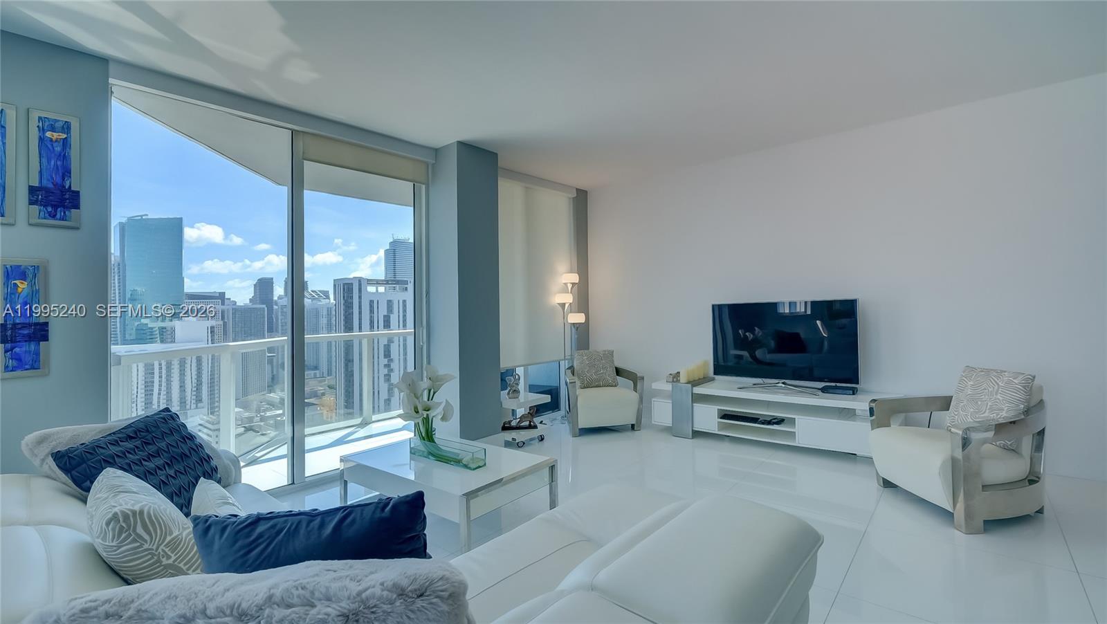 253 Northeast 2nd Street, Unit 3509 Miami, FL 33132 - Photo 43 of 49 a living room with furniture and a flat screen tv