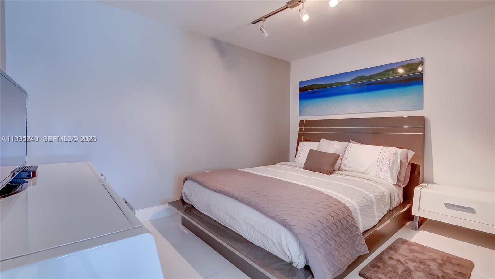 253 Northeast 2nd Street, Unit 3509 Miami, FL 33132 - Photo 45 of 49 a bedroom with a bed and a window
