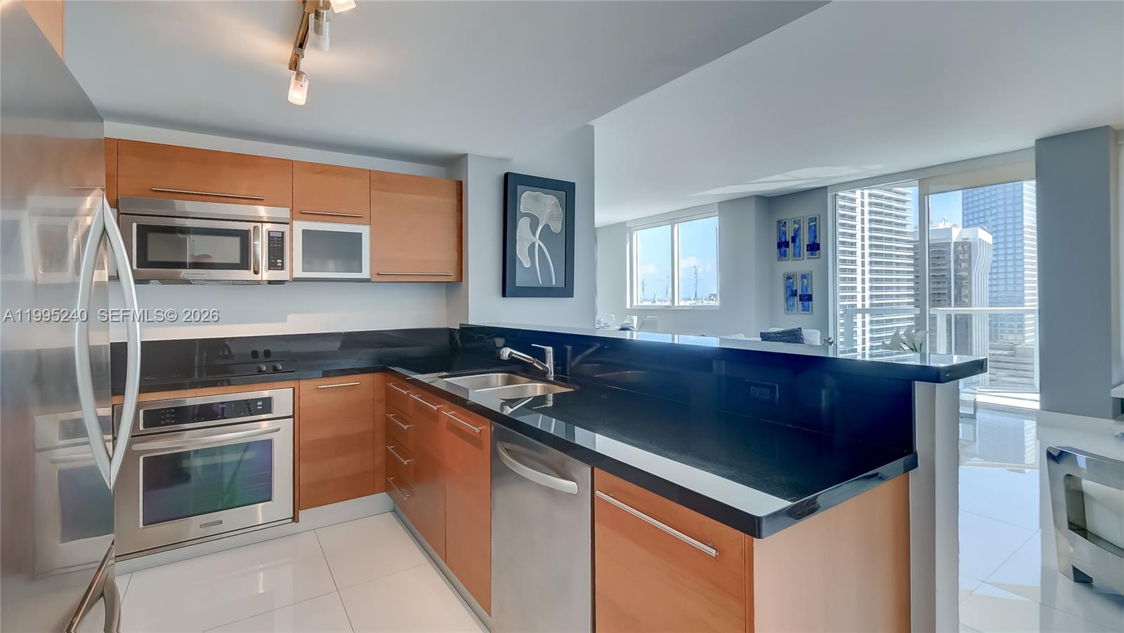 253 Northeast 2nd Street, Unit 3509 Miami, FL 33132 - Photo 48 of 49 a kitchen with granite countertop a sink and a stove