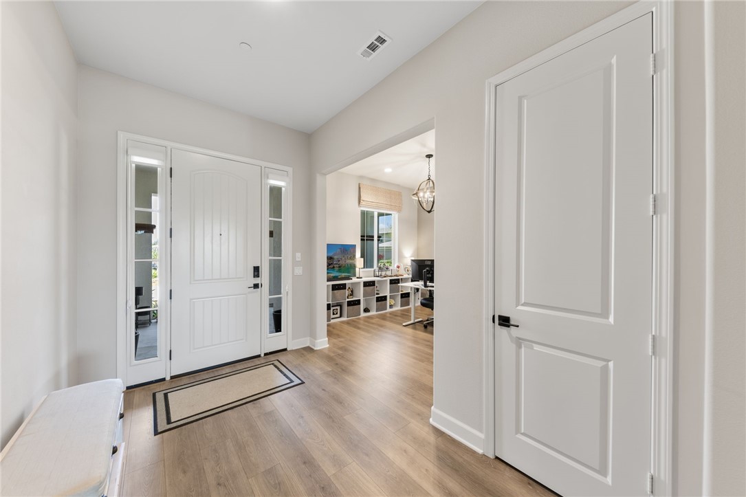 Bright and welcoming entryway with luxury vinyl plank flooring.