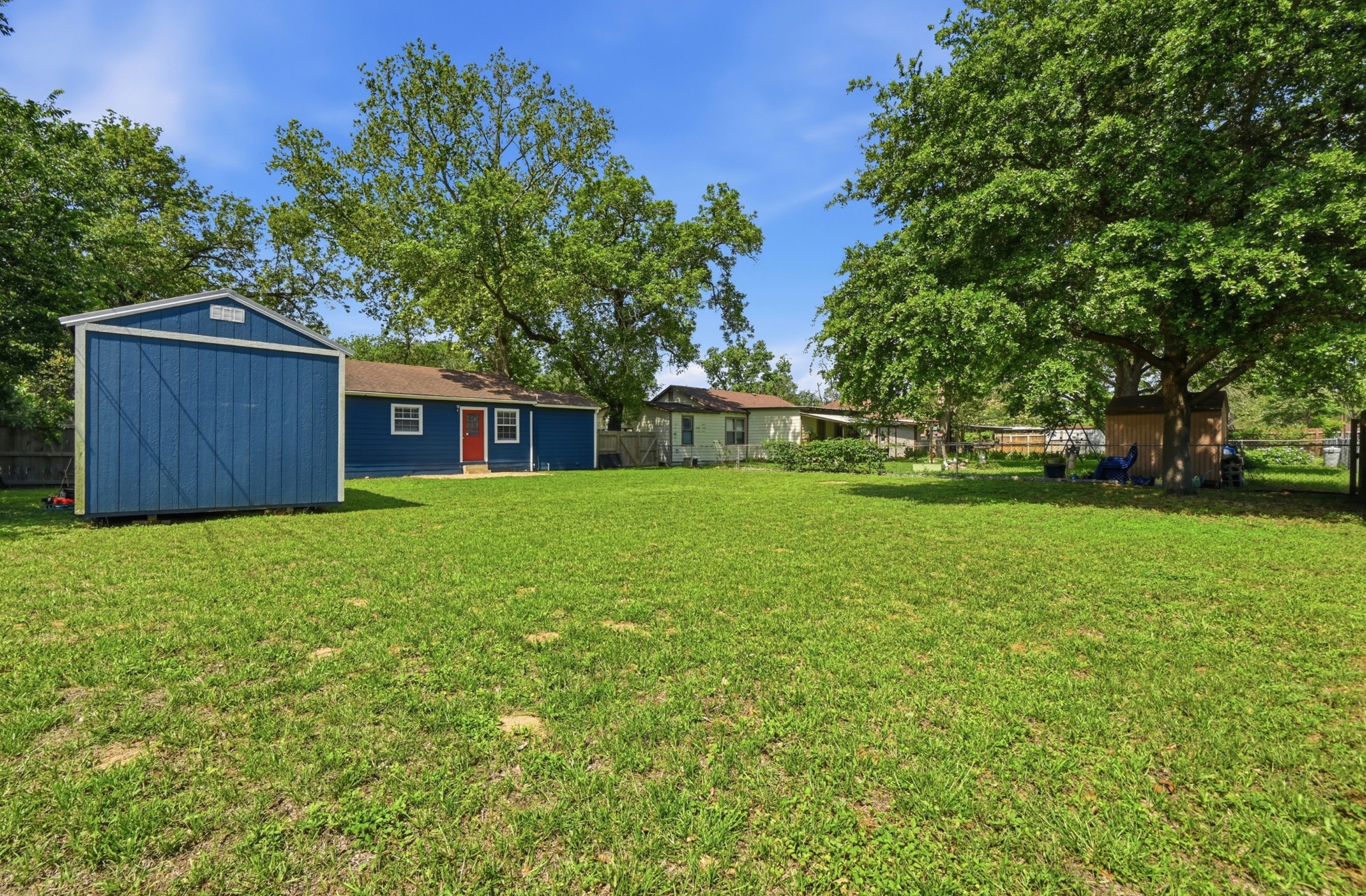 1127 Parr Street Luling, TX 78648 - Photo 18 of 20 A spacious, verdant yard awaits outdoor enjoyment, complemented by mature trees and a functional shed.