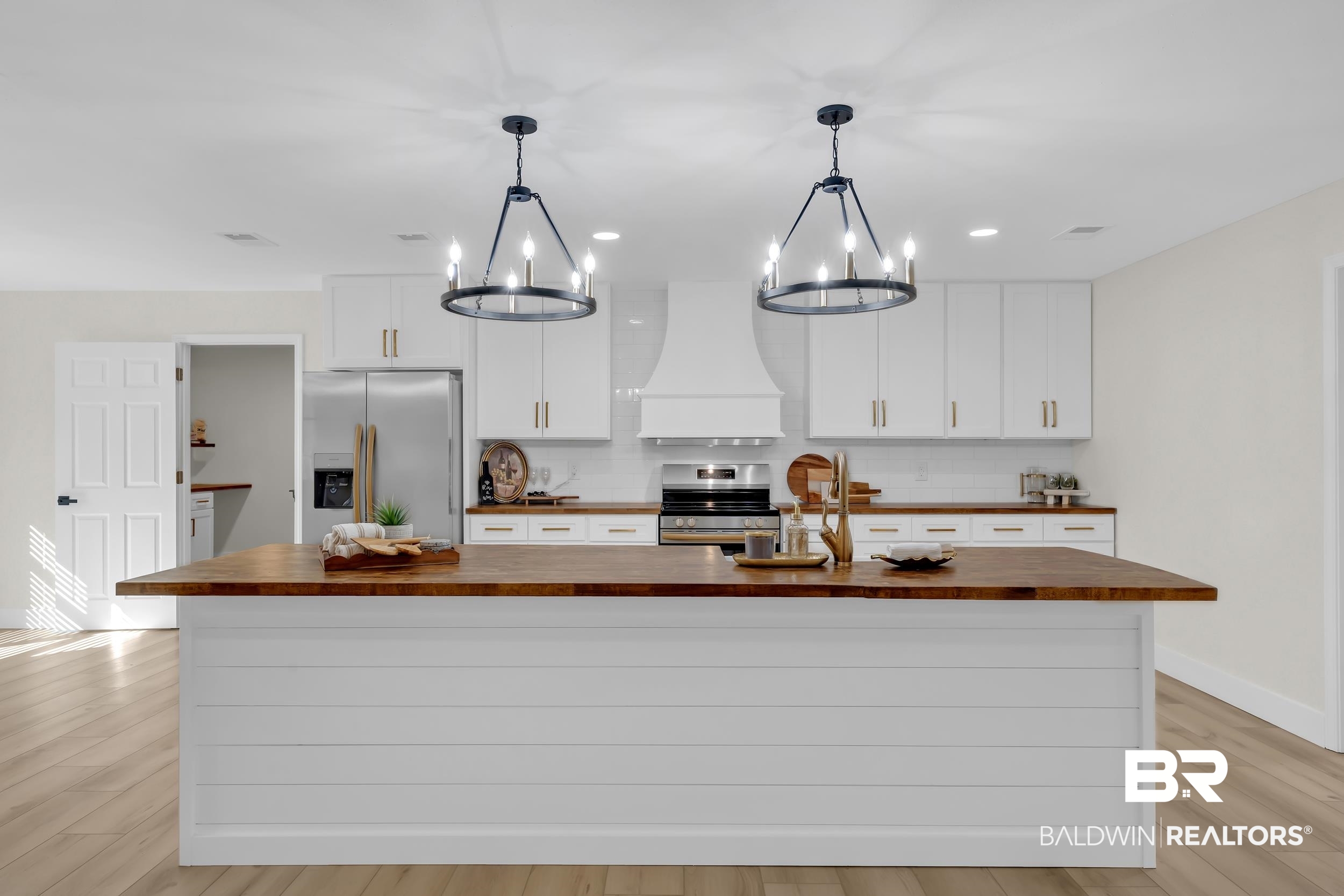 8170 Wilmer Georgetown Road Wilmer, AL 36587 - Photo 6 of 31 Central kitchen island featuring a wood-finish countertop and shiplap paneling