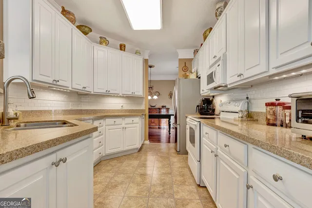 a kitchen with stainless steel appliances granite countertop a sink stove and cabinets