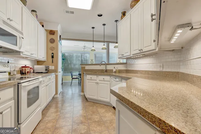 a kitchen with cabinets and outdoor space