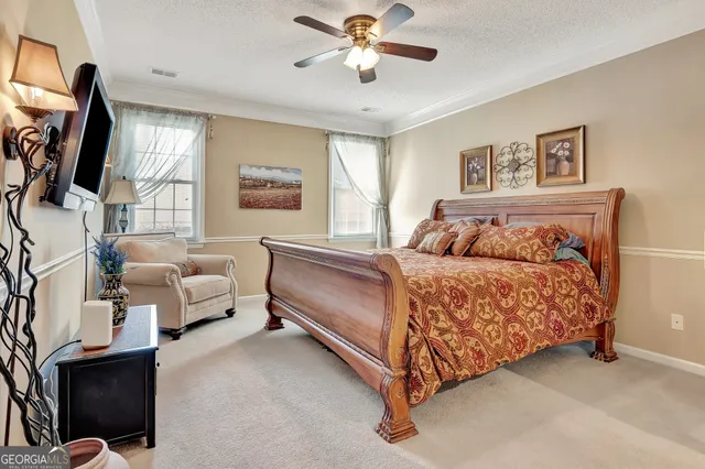 a bedroom with a bed and a flat screen television