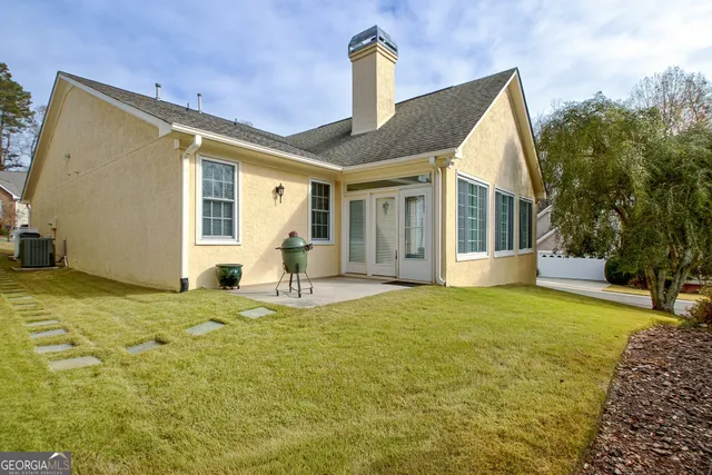 a house view with swimming pool in front of it