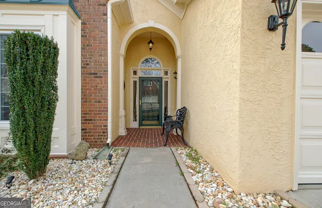 a view of a brick house with potted plants