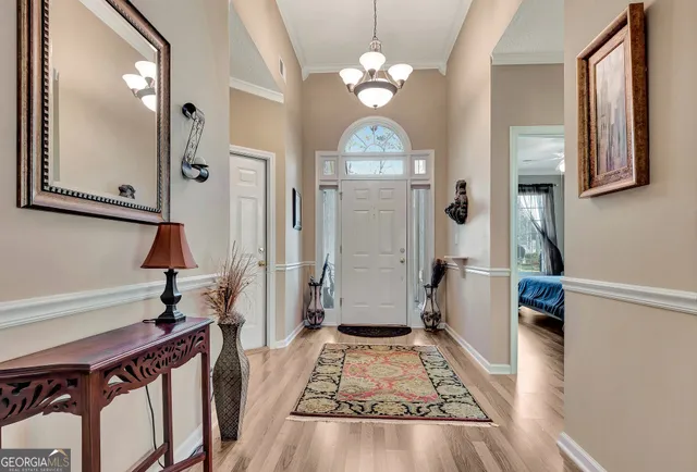 a view of a hallway view with living room and wooden floor