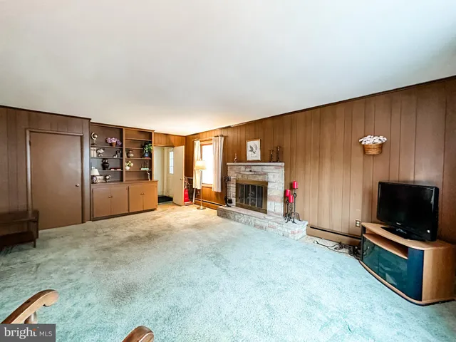 a view of empty room with a fireplace