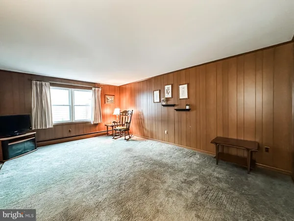 a view of a livingroom with furniture and a window