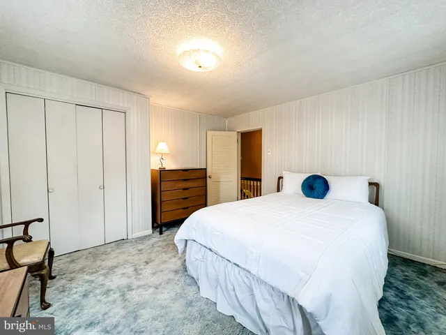 a bedroom with a bed and a dresser