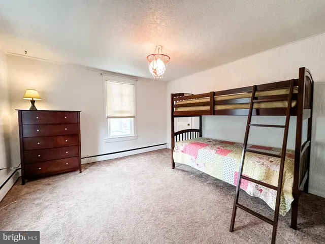 a bedroom with furniture and a window