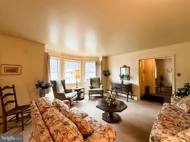a living room with furniture and large windows
