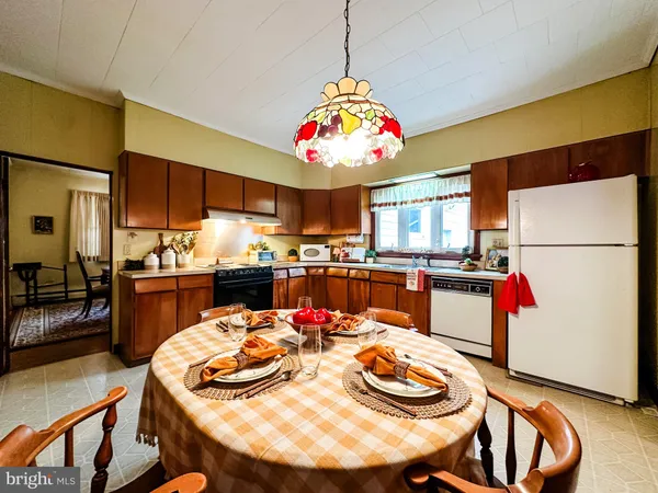 a kitchen with a dining table and chairs