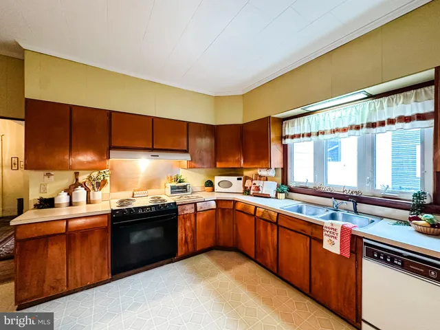 a kitchen with stainless steel appliances granite countertop sink stove and cabinets