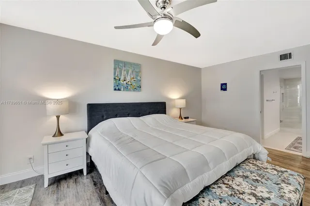 a en suite bathroom with a tub double vanity and mirrors