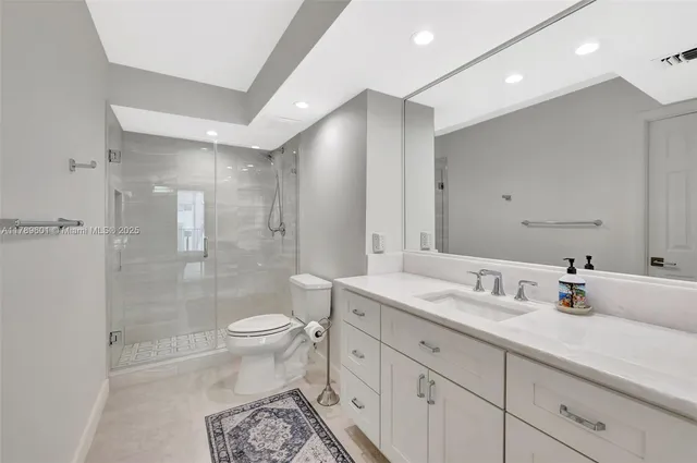 a bathroom with a shower a toilet and sink