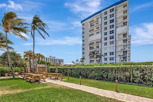 a view of a patio with a table and chairs