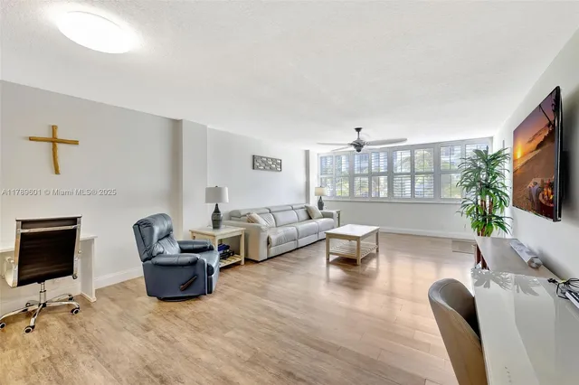a living room with furniture or couch and a ceiling fan